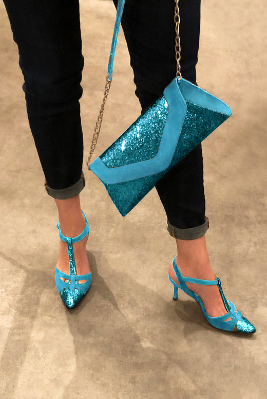 Turquoise blue women's open back T-strap shoes. Tapered toe. High slim heel. Worn view - Florence KOOIJMAN
